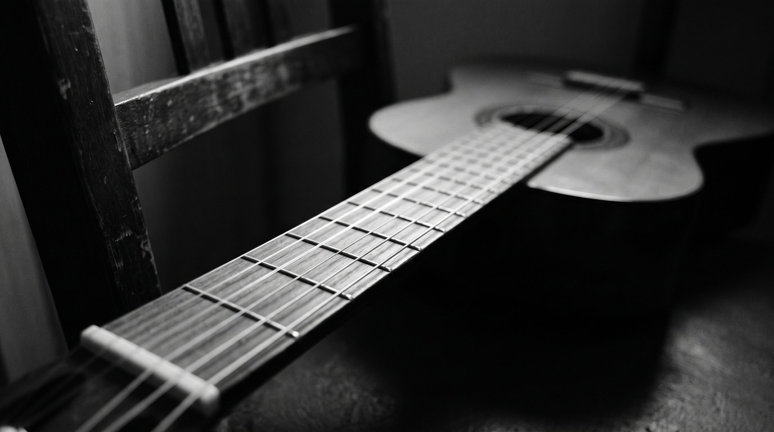 Fretboard of a classical guitar in low light, for a lesson on the Hungarian minor scale